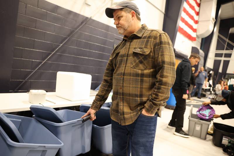 Pastor Chad Dalton shows examples of needed supplies at Grace Christian Academy on Thursday, March 12, 2026, following the EF-3 tornado that tore through Kankakee County on March 10. The school, which is on the outskirts of Aroma Township along Waldron Road, canceled classes in order to become a supply and meal hub for those impacted by the storm.