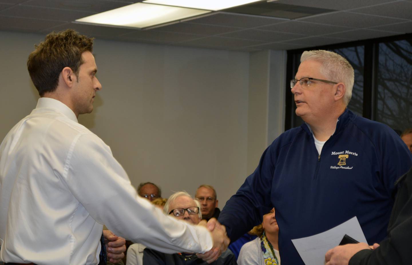 Mt. Morris Village President Phil Labash shakes hands with Mt. Morris Police Chief Michael Cicchetti after swearing him in during the April 12 village board meeting. Cicchetti replaces Chief Jason White, who retired after 35 years with the Mt. Morris Police Department.