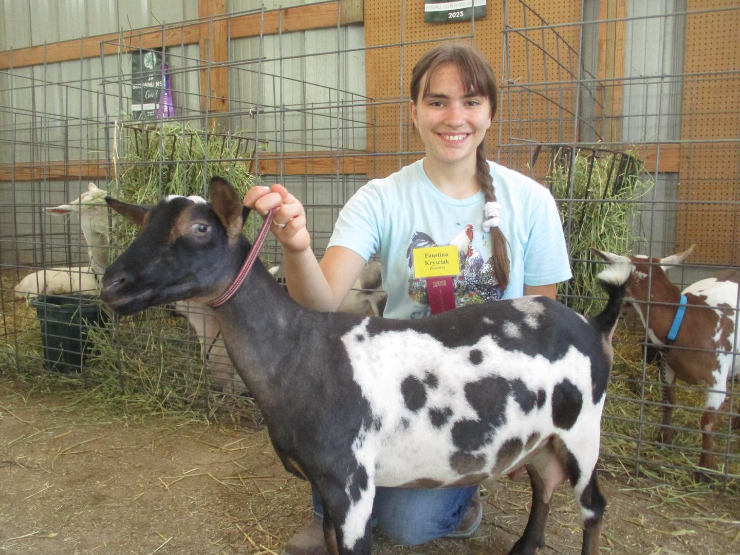 Faustina Krysciak of Yorkville displays her goat April, a champion dairy milker, at the Kendall County Fair on Aug. 3, 2023.