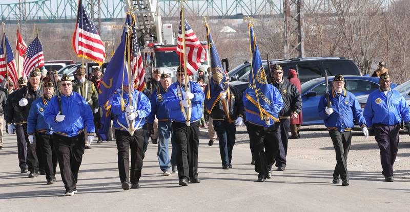Ladd and Spring Valley Veterans march underneath a giant American Flag during the annual Pearl Harbor parade and memorial service on Saturday in Peru. This year marks the 83rd anniversary of the Dec. 7, 1941, attack on Pearl Harbor.