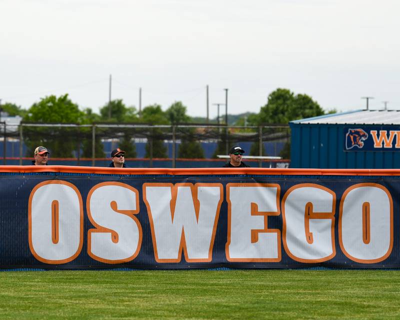 Spectators line the home run fence during the softball regional final game as Oswego took on Benet Academy on Friday May 22, 2026, that was played at Oswego High School.