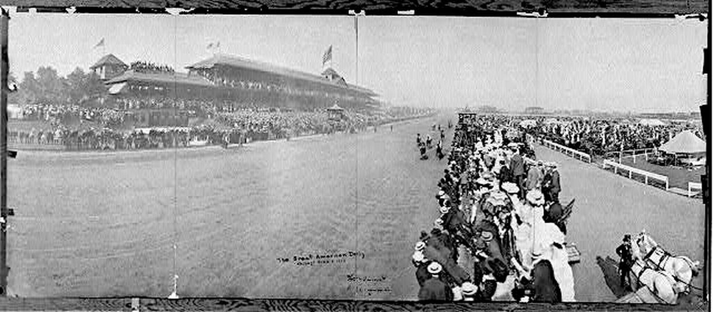 As crowd of spectators watch horses run in the 1904 American Derby in Chicago.
