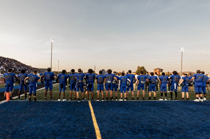 Lincoln-Way East’s varsity football team stands for the National Anthem prior to a varsity football game against Metea Valley at Lincoln-Way East on Oct. 3, 2025.
