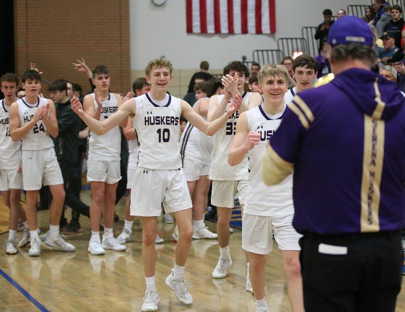 Members of the Serena boys basketball team accept the  Little Ten Conference Championship trophy after defeating Earlville on Friday, Feb. 2, 2024 at Somonauk High School.