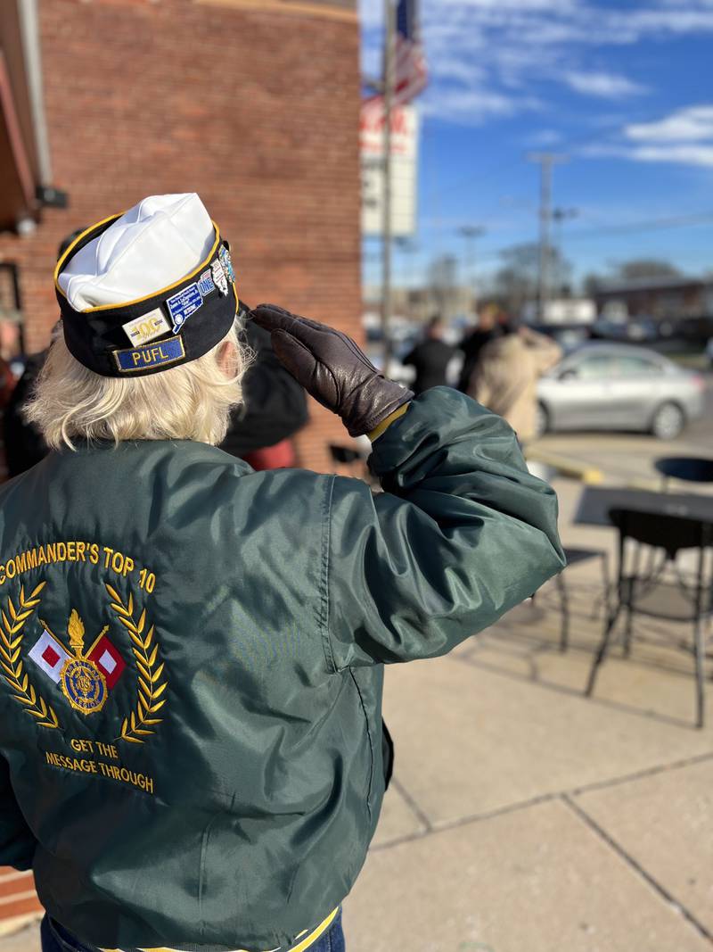 A veteran salutes as the flag is lowered to half-staff in remembrance of Pearl Harbor at the Veterans of Foreign Wars Post 2470 in Ottawa on Dec. 7, 2024.