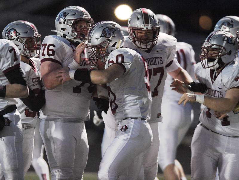 Antioch's Lucas Bentley, middle, celebrates with teammates after his forced fumble, recovery and run for a touchdown against Grant in a football game in Fox Lake Friday, April 16, 2021.