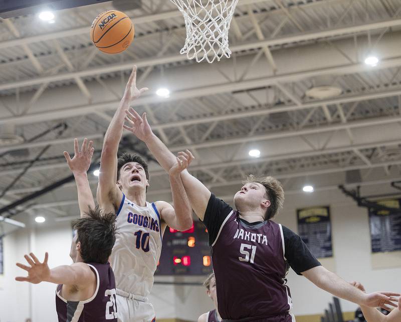 Eastland’s Zyacn Haverland puts up a shot against Dakota’s Micah Schrader (left) and Jacob Seiver Wednesday, March 5, 2025, during the Class 1A boys basketball Sectional semifinal at Pecatonica High School.