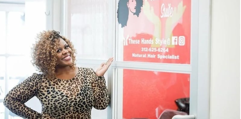 Licensed cosmetologist and natural hair specialist Ashanti Johnson stands in front of her salon, These Hands Style in Oak Lawn, Illinois. Johnson attributes her success as a stylist to her decision to be licensed.