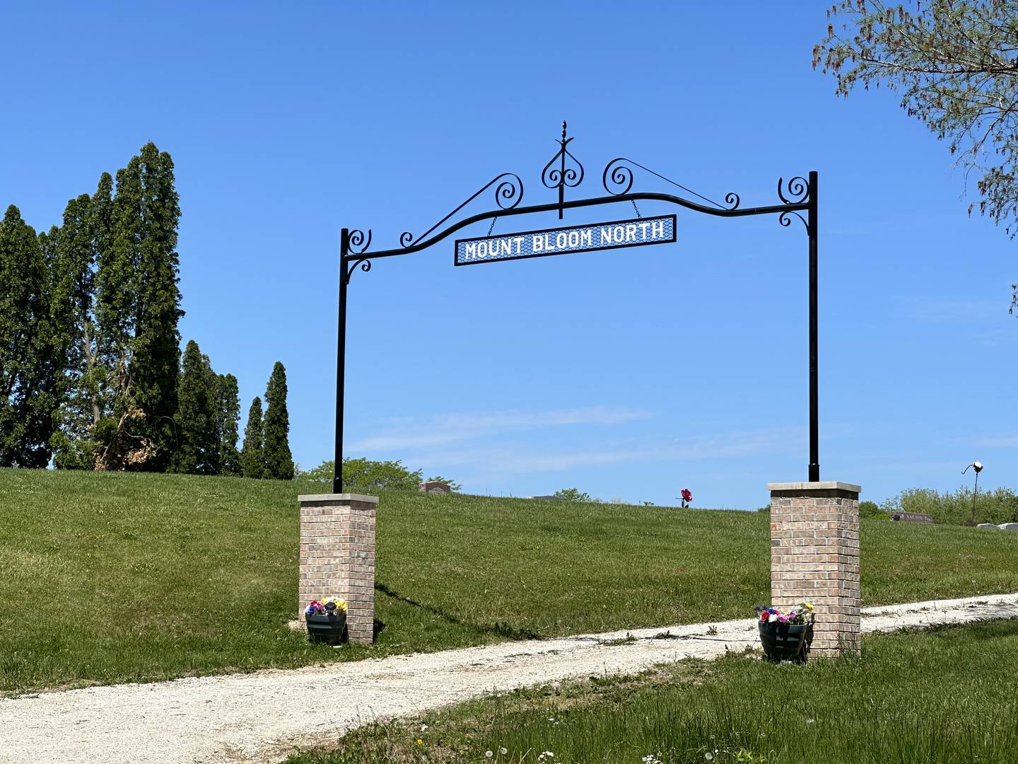 Last fall the brick columns were constructed by Alvaro Cadena and over the winter Doc and Tom Schertz donated the labor to craft a new arch matching the metalwork on the south entrance.