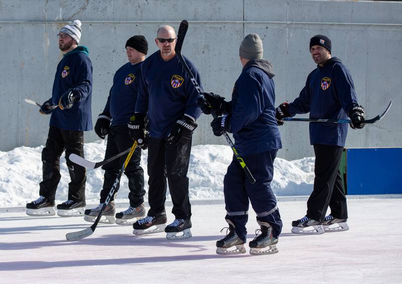 The Wheaton Police Departments hockey team talks before their game against the Wheaton Fire Department during the Wheaton Park District's Ice-A-Palooza at the Central Athletic Complex  in Wheaton on Saturday, Feb. 4, 2023.