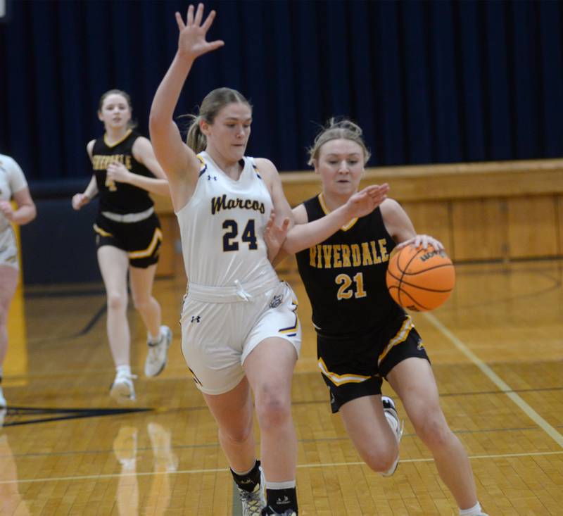 Riverdale's Cayleigh Hungate drives to the basket as Polo's Katelyn Rockwood defends on Saturday, Jan. 18, 2025 at Polo High School.