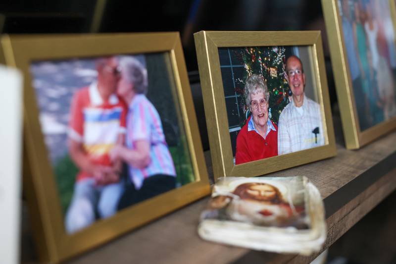 The prayer book used by Pat McCarty lays next to photos of Pat and her husband, Wayne, both of Bradley, on Tuesday, July 15, following the celebration of life services for the couple held July 14.
