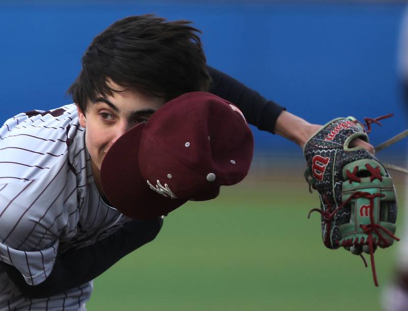 The wind blows off Richmond-Burton's Grayson Morningstar’s cap as he throws a pitch during a Kishwaukee River Conference baseball game on Monday, April 6,2026, at Johnsburg High School.