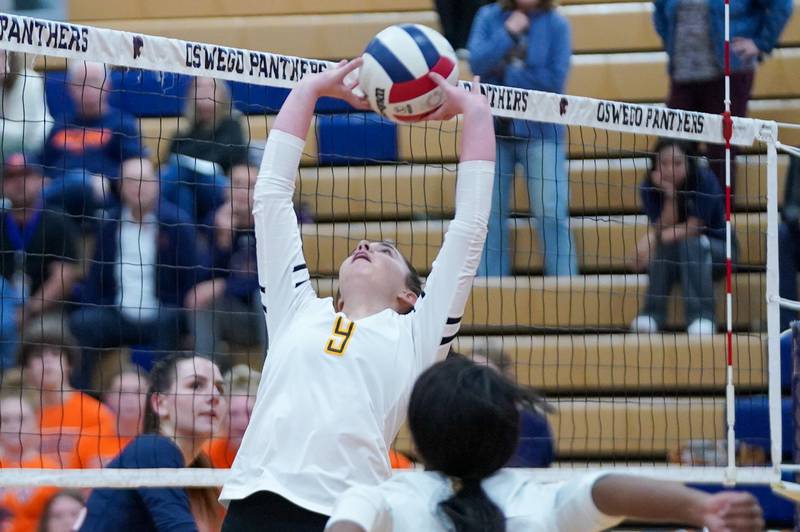 Joliet West's Julia Adams (9) back sets the ball during a volleyball match against Oswego at Oswego High School on Thursday, October 24, 2024.