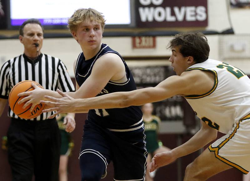 Cary-Grove's Landon Nawracaj looks top pass the ball as he is guarded by Crystal Lake South's Anthony Santarelli during the IHSA Class 3A Prairie Ridge Regional championship basketball game on Friday, Feb. 28, 2025, at Prairie Ridge High School in Crystal Lake.