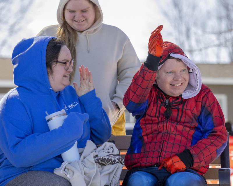 Jared Sheaves waves and cheers on plunge participants as they head into the water during the Polar Plunge for Special Olympics on February 22, 2025 at Lake Mendota.