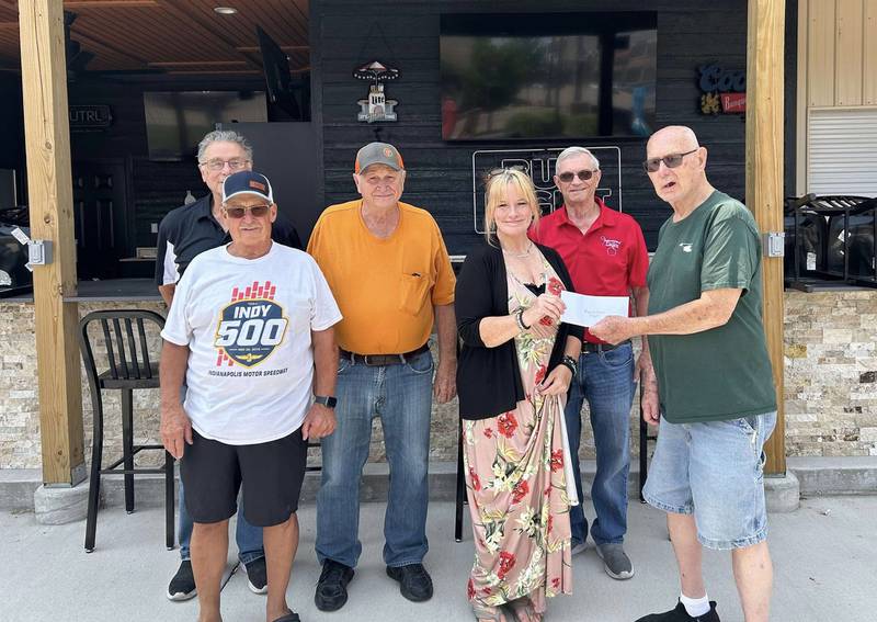 Streator Eagles Club members (from left) Dan Casey, conductor; Jerry Longnecker, Bob Kincaid; Ed Kimber, past state president; and Harry Degenhart, secretary; present (fourth from left) Melissa Calkins-Crank, director of Logan's Oasis, with a $1,000 check for Logan's Oasis to build a new playground at Marilla Park in memory of Logan Crank.