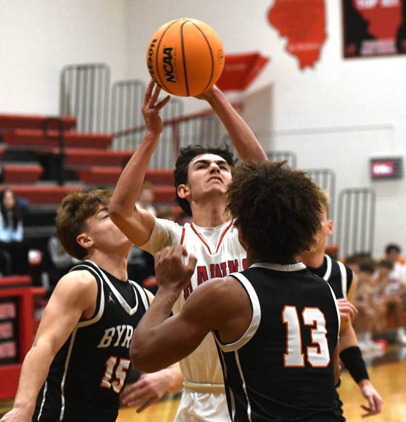 Oregon's Benny Olalde (1) shoots as Byron's Ben Hively (15) and JJ Edmonson (13) on Monday, Dec. 15, 2025 at the 64th Forreston Holiday Tournament at Forreston High School.