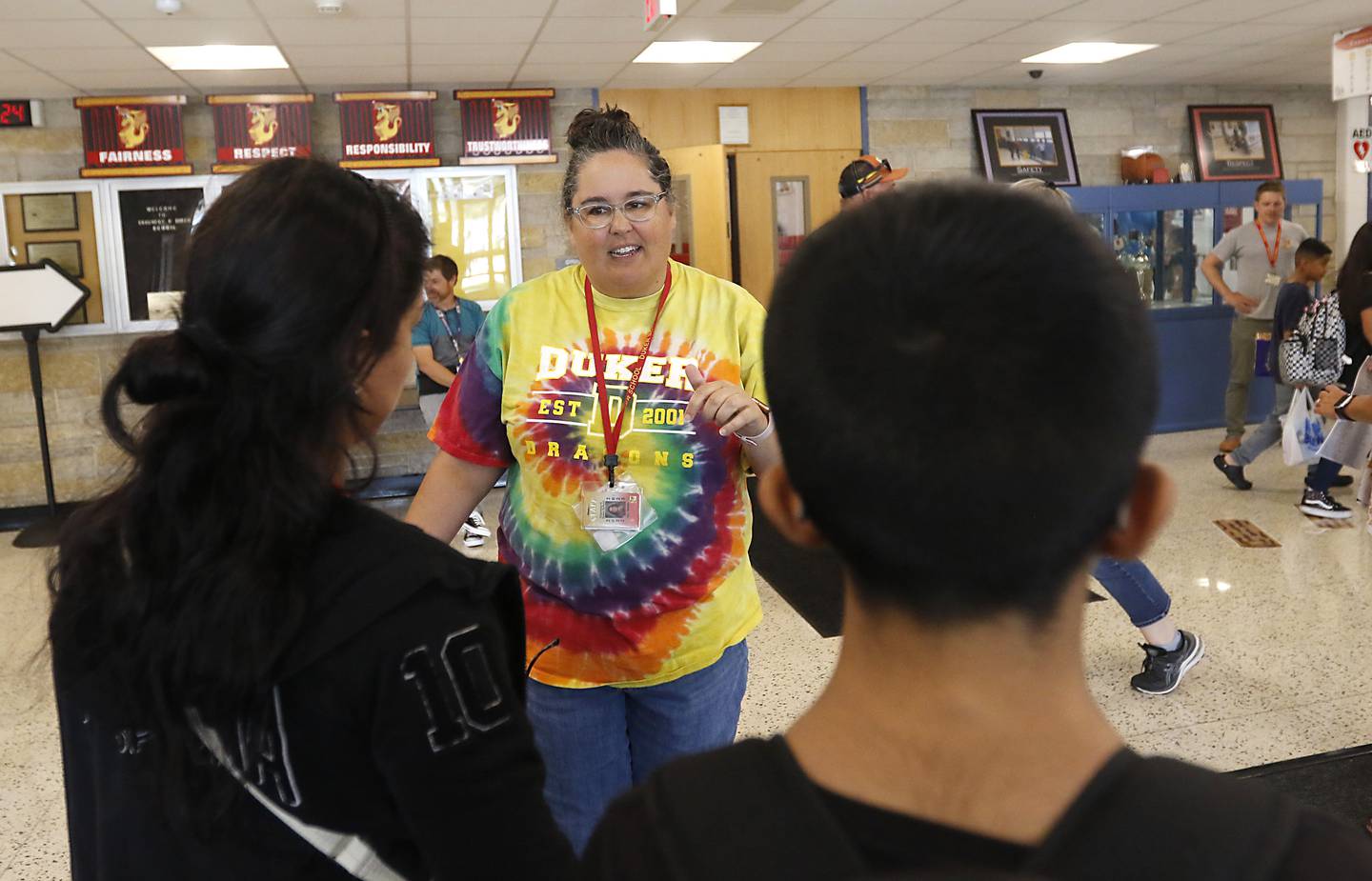 Teacher Sarah Nowak greats students and parents as they arrive at Duker Elementary School in McHenry, on Tuesday, Aug. 15, 2023, during school supplies drop-off day.
