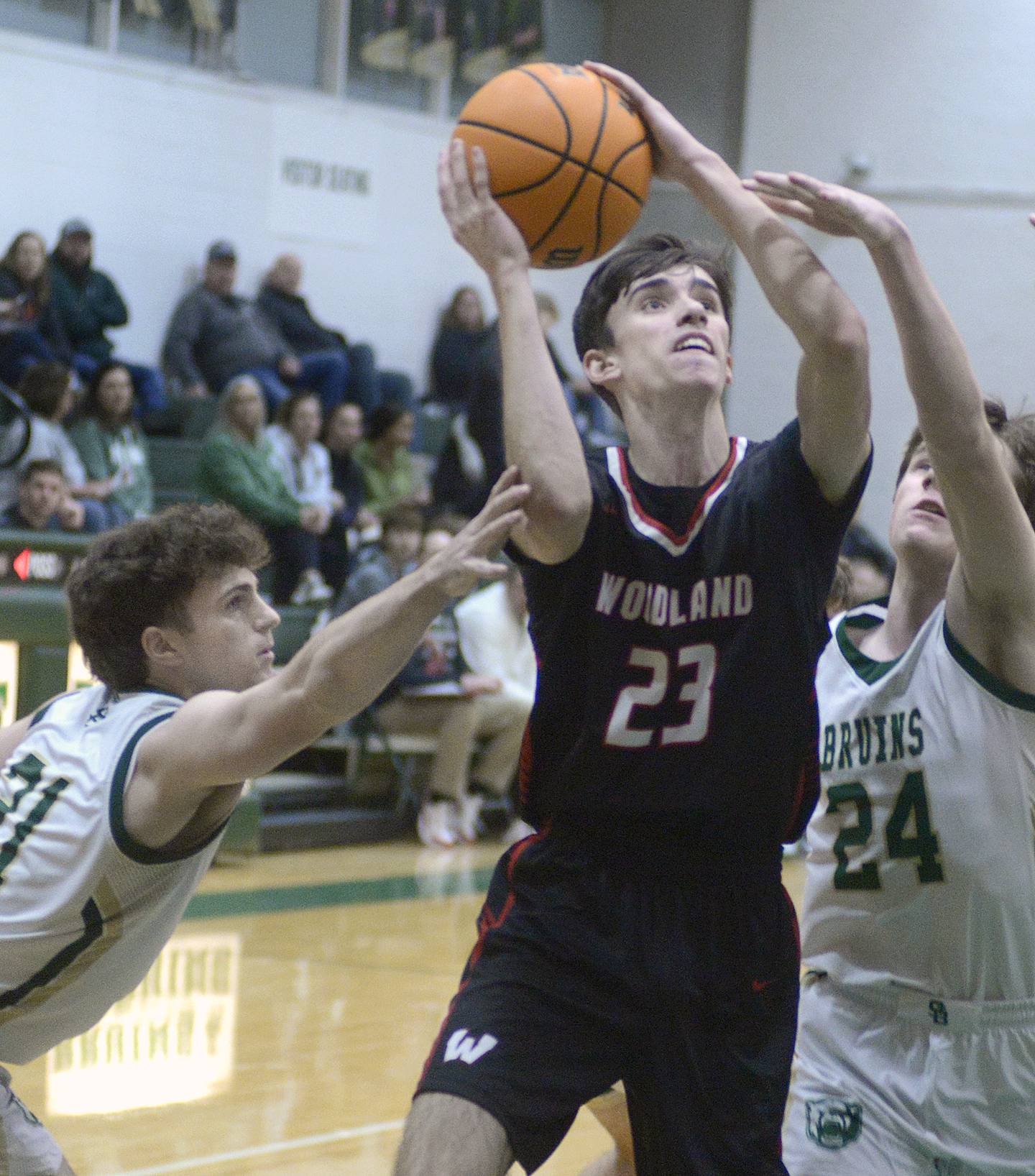 Woodland’s Nick Plesko splits the defense of St Bede’s August Burr and Phillip Gray in the first quarter of a game earlier this season at St Bede.