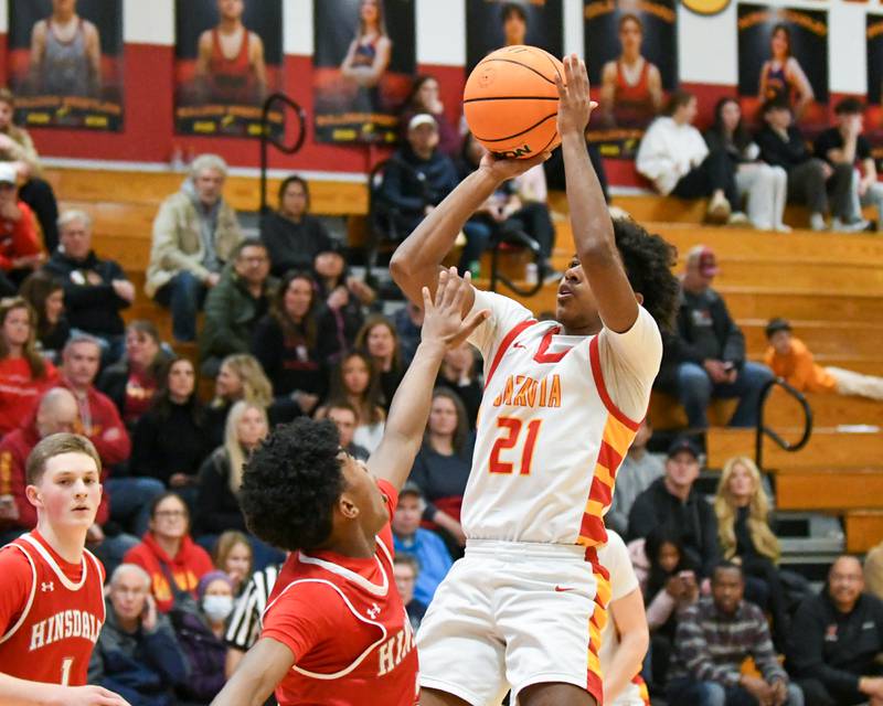 Batavia's Xavier Justice (21) makes a shot during the game on Saturday Jan. 24, 2026, while being defended by Hinsdale Central's RJ Lewis (2) held at Batavia High School.