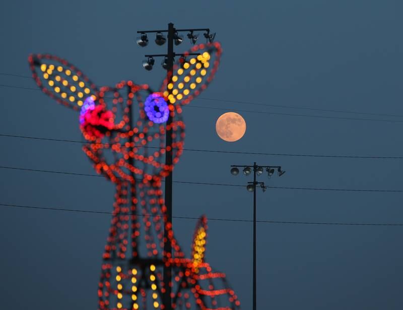 A full moon rises over Rudolph during the Celebration of Lights on Thursday, Dec. 8, 2022 at Rotary Park in La Salle.
