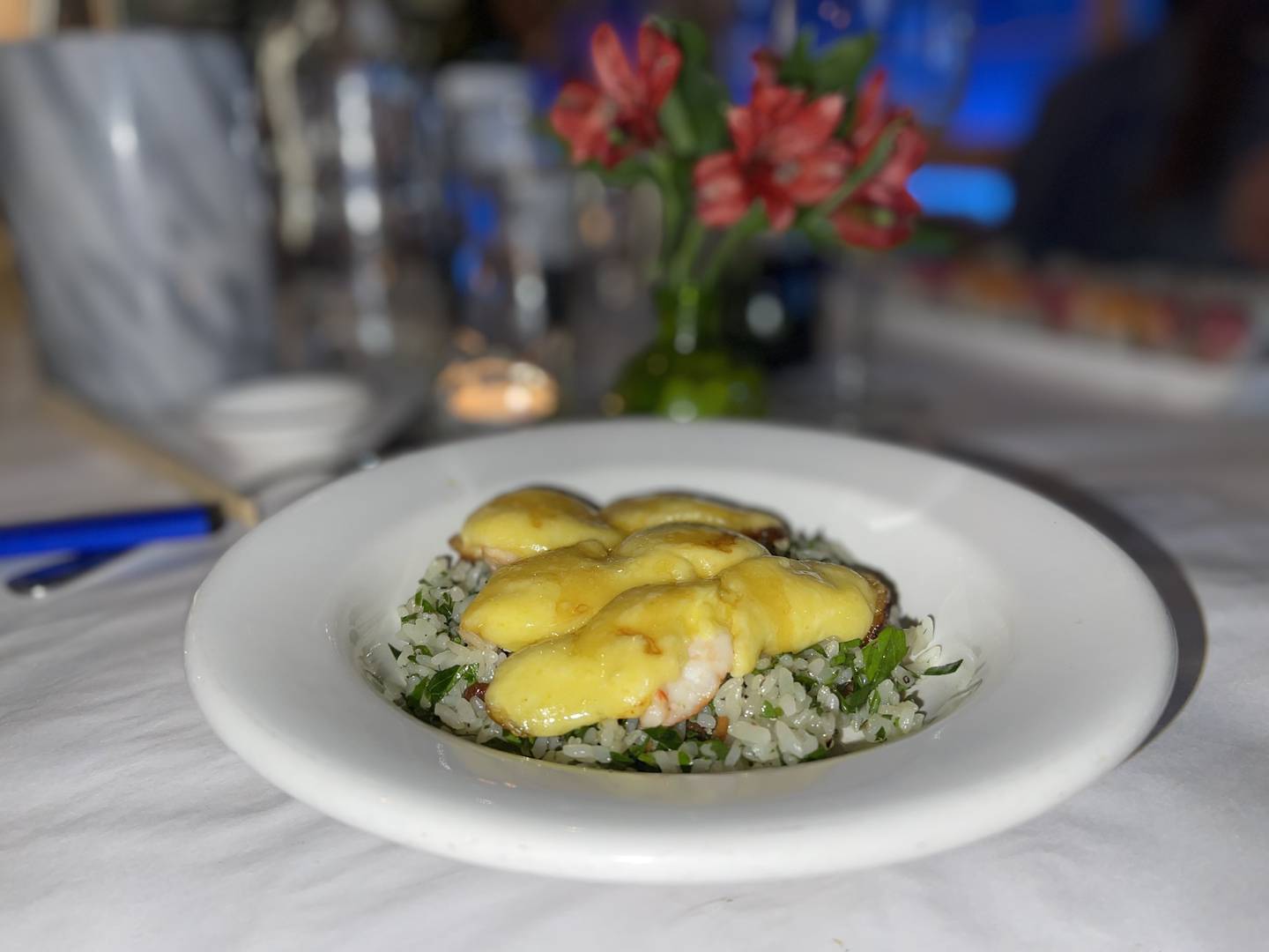 Golden Shrimp appetizer, butterflied shrimp steam-grilled with golden sauce and served on garlic rice.