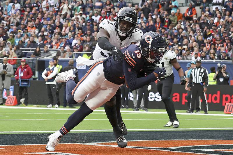 Chicago Bears wide receiver Keenan Allen (13) catches the ball to score his side's third touchdown during the third quarter of an NFL football game at the Tottenham Hotspur stadium between the Jacksonville Jaguars and Chicago Bears in London, Sunday, Oct. 13, 2024. (AP Photo/Ian Walton)