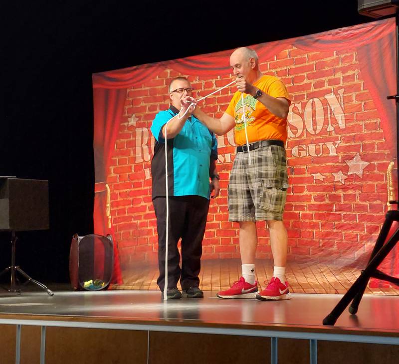 Mark Astle assists magician Rob Thompson during a show Wednesday, June 21, 2023, presented by Ottawa Recreation at Central Intermediate School.