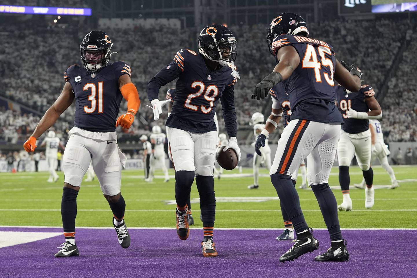 Chicago Bears cornerback Tyrique Stevenson (29) celebrates with teammates after intercepting a pass during the first half of an NFL football game against the Minnesota Vikings, Monday, Dec. 16, 2024, in Minneapolis. (AP Photo/Abbie Parr)