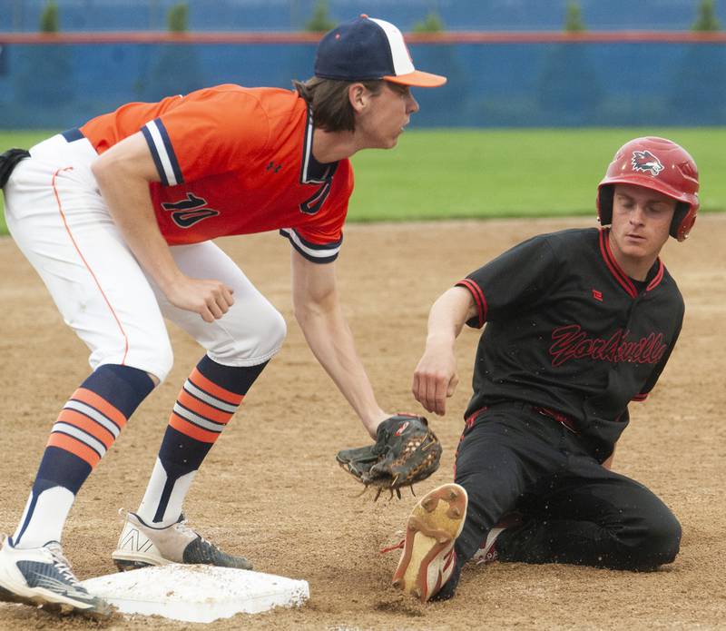 Oswego third baseman Andrew Hart (10) tags out Yorkville base runner Brandon Johnson during a varsity boys baseball game on Wednesday, May 18, 2022 at Oswego High School.