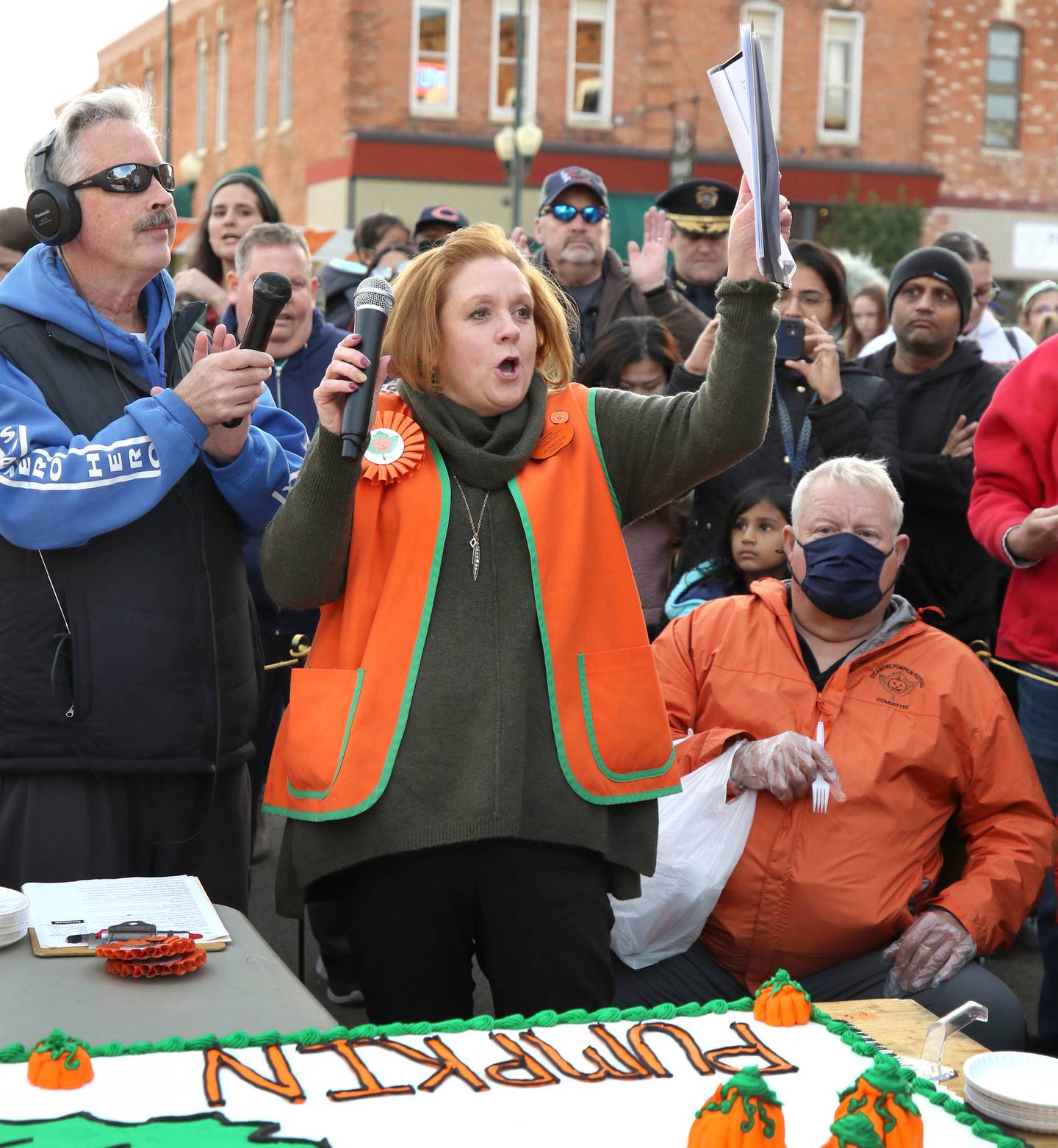 Jennifer Diehl, Sycamore Pumpkin Festival Committee president, cheers prior to the cake-cutting ceremony Wednesday, October 27, 2021, on North Maple Street, as she thanks other members of the committee and those who helped put together the festival.