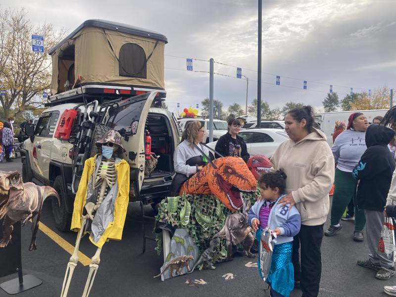 Members of the Joliet AFSCME Joliet Employees Local 440 union pass out candy from the Jurassic Park themed trunk. 
Saturday, Oct. 25, 2025.