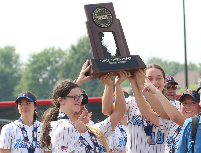 Members of the Oak Park River Forest softball team hoist the Class 4A third place trophy after beating Lockport on Saturday, June 14, 2025 at the Louisvile Slugger Complex in Peoria.