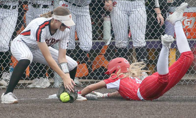 Bradley-Bourbonnais's Bella Pusateri slides safe into third base as Edwardsville's Grace Oertle misses the tag during the Class 4A Supersectional game on Friday, June 6, 2025 at Monticello High School.