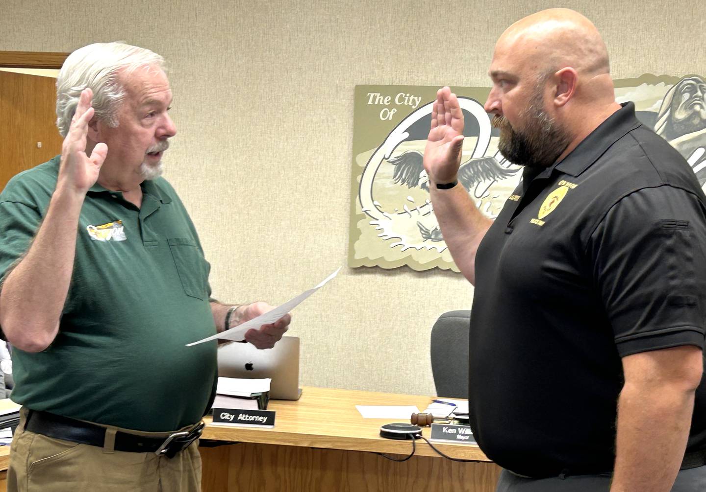 Oregon Mayor Ken Williams (left) swears in Matt Kalnins as Oregon's new police chief on Tuesday, Aug. 13, 2024. Kalnins had been serving as interim chief.