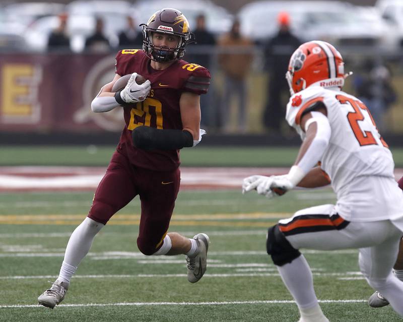 Richmond-Burton's Luke Johnson runs with ball as Byron’s Jj Edmonson closes in during an IHSA Class 3A semifinal playoff football game on Saturday, November 22, 2025, at Richmond-Burton High School, in Richmond.
