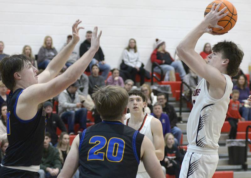 Woodland’s Nate Berry eyes the basket over the block attempt by Somonauk’s Kaden Geers-Clason  in the 2nd period Wednesday at Woodland.