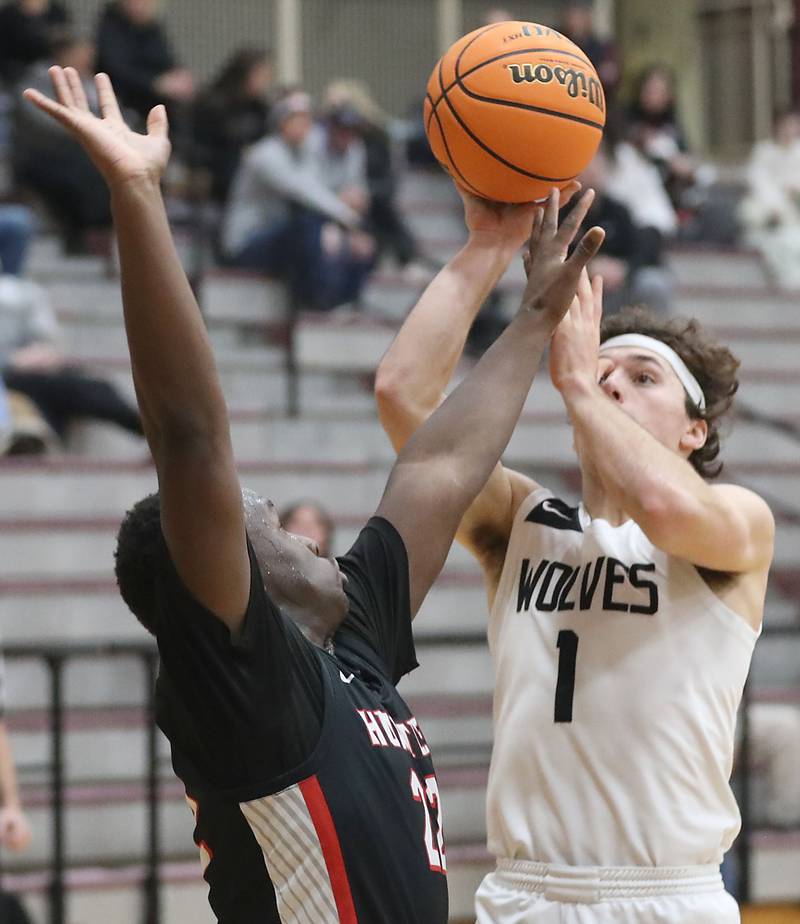 Prairie Ridge's Luke Vanderwiel tries to shoot the ball over Huntley's Seun Oladipo during a Fox Valley Conference boys basketball game on Wednesday, Jan. 21, 2026, at Prairie Ridge High School in Crystal Lake.