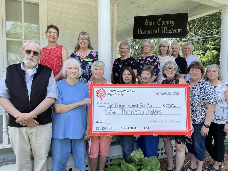 100 Women Who Care of Ogle County presented the Ogle County Historical Society with a donation of $7,000. Pictured here, in the front row are David Head (director at OCHS), Marlene Hobbs (director at OCHS), Christa Young, Kris Gilbert (vice president at OCHS), Jan McMillan (treasurer at OCHS), Julie Mastney (100WWC), Julie Mann (100WWC), and Karen Urish (100WWC). Back row: Maja Shoemaker (100WWC), Jennifer Bakener (100WWC), Dede Forrest (100WWC), Pam Steele (100WWC), Becky McCanse (100WWC), Debby Katzman (100WWC) and Michal Burnett (Facebook Administrator and Tours and Programs Director at OCHS.