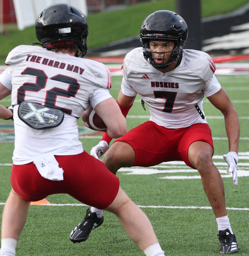Northern Illinois University safety Justin Harris (right) looks to make a tackle Tuesday, April 14, 2026, during a drill at spring practice in Huskie Stadium at NIU in DeKalb.