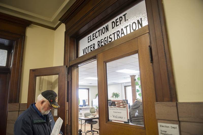 Michael Koppien waits outside of the Lee County election department Monday, March 7, 2022 on the first day of filing for the primary general election. Koppien is running for a county board seat for District 1.