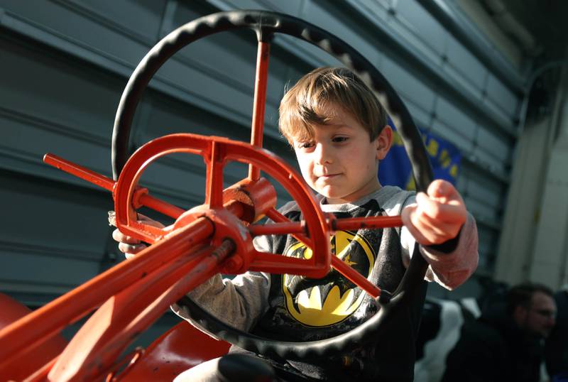 Hunter Joiner, 5, from Sycamore, sits atop a vintage tractor Wednesday, Feb. 25, 2026, during the DeKalb High School Future Farmers of America Barnyard Zoo. The event was open to the public and offered the chance to learn about farming and see farm animals up close.