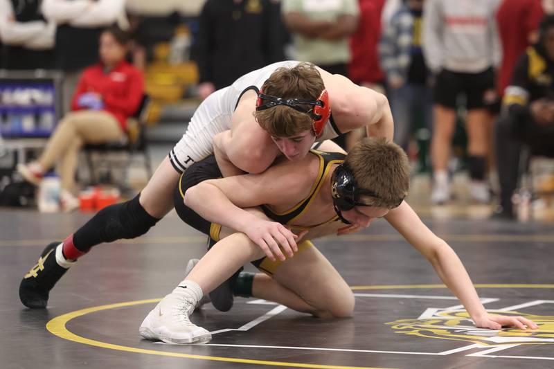 Maddox Garbis of Plainfield North works over Jakob Crandall of Joliet West in the 113-pound weight SPC Conference championship match at Joliet West on Saturday, Jan 25, 2025.