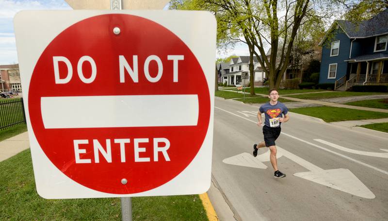 Runners make the last turn toward the finish line of the 2023 Super Hero 5k Fun Run in Wheaton on Saturday, April 15, 2023.