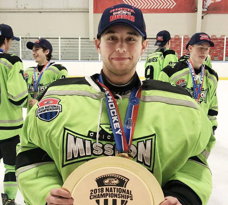 Chicago Mission hockey goaltender Nick Addante, a sophomore at Jacobs, holds the national championship trophy.
