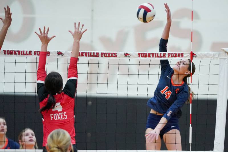 Oswego’s Mia Jurkovic (14) goes up for a kill attempt against Yorkville's Addisyn Gardner (4) during the Class 4A Yorkville Regional final at Yorkville High School on Thursday, Oct. 31, 2024.
