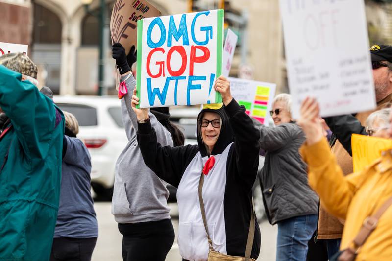 Joliet resident Linda Atkinson holds up a sign at the Hands Off protest in Downtown Joliet on April 5, 2025.