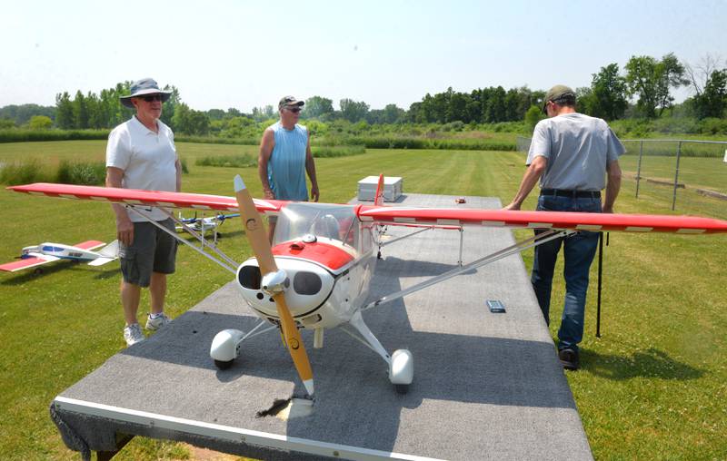 Richard Lego (left) of Rock Falls and John O'Brien (center) of Harmon, stand by a model aircraft replica of a 1946 Taylorcraft at the Morrison Model Aircraft Flyers area inside Morrison-Rockwood State Park on Sunday, June 4.