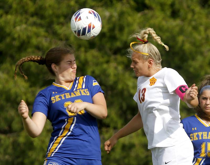 Richmond-Burton's Jordan Otto (right) heads the ball away from Johnsburg's Kiara Welch during the IHSA Class 1A Marian Central Sectional Championship match on Tuesday, May 21, 2024, at Marian Central High School.